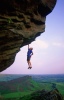 Ben Heason hanging from the lip of Paralogism E7, Roaches a route he soloed without practice